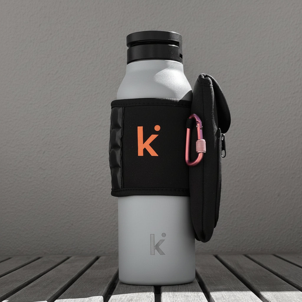 Thermos bottle with black bag and pink carabiner on a wooden surface against a brown background